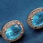 Feshionn IOBI Earrings Oval Solitaire Halo Earrings in Sapphire, Emerald, Topaz or White CZ